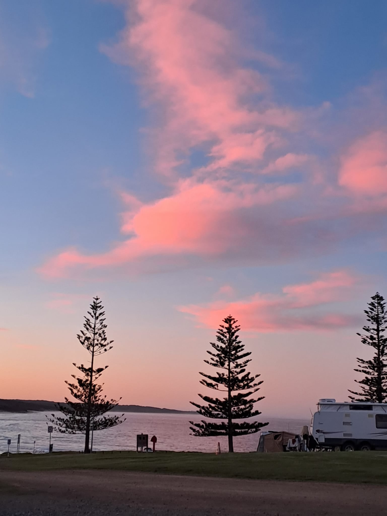 dalmeny campground sunset with pink sky and campervan overlooking the sea