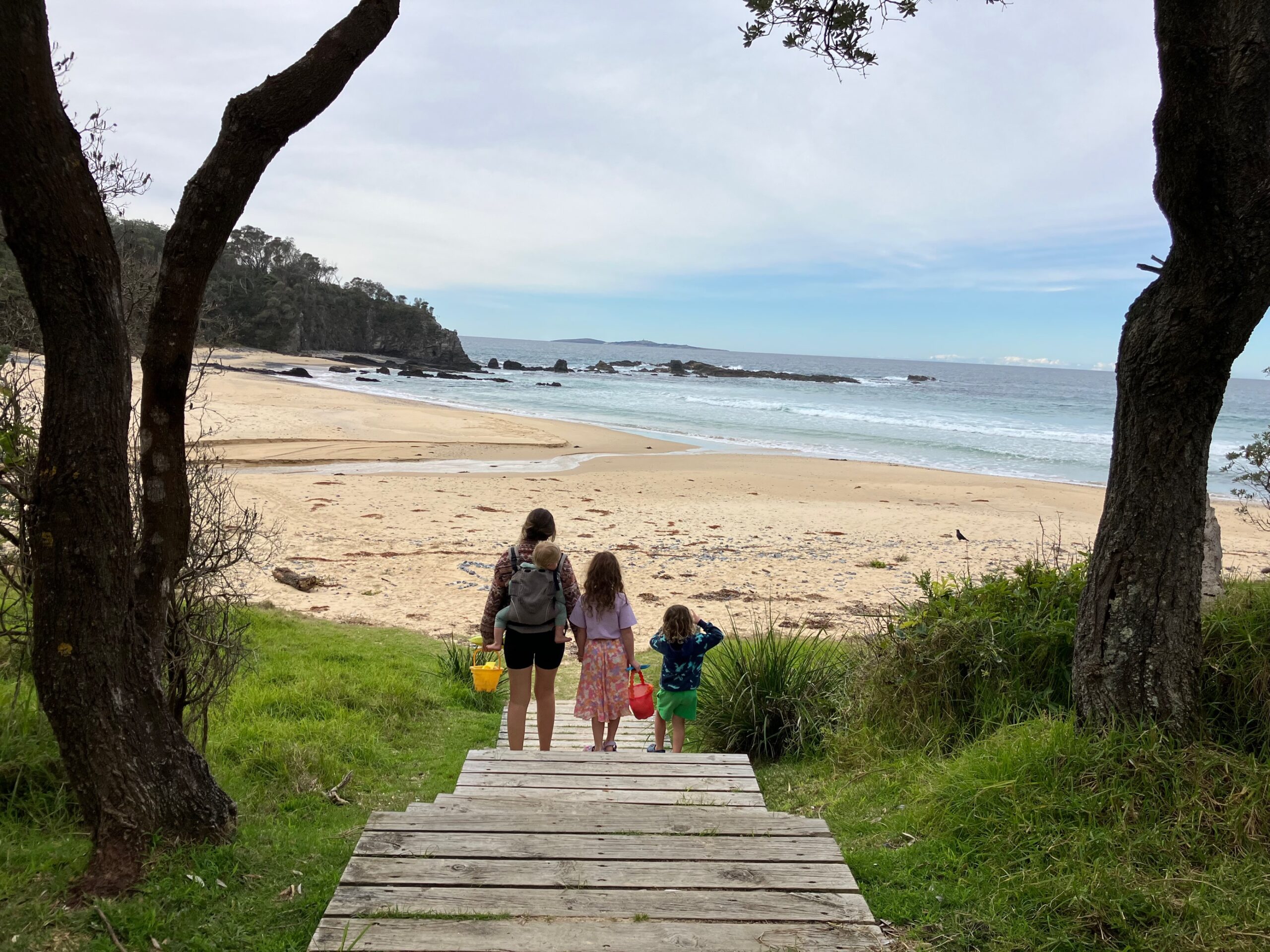 mystery bay campground family walking to beach on boardwalk