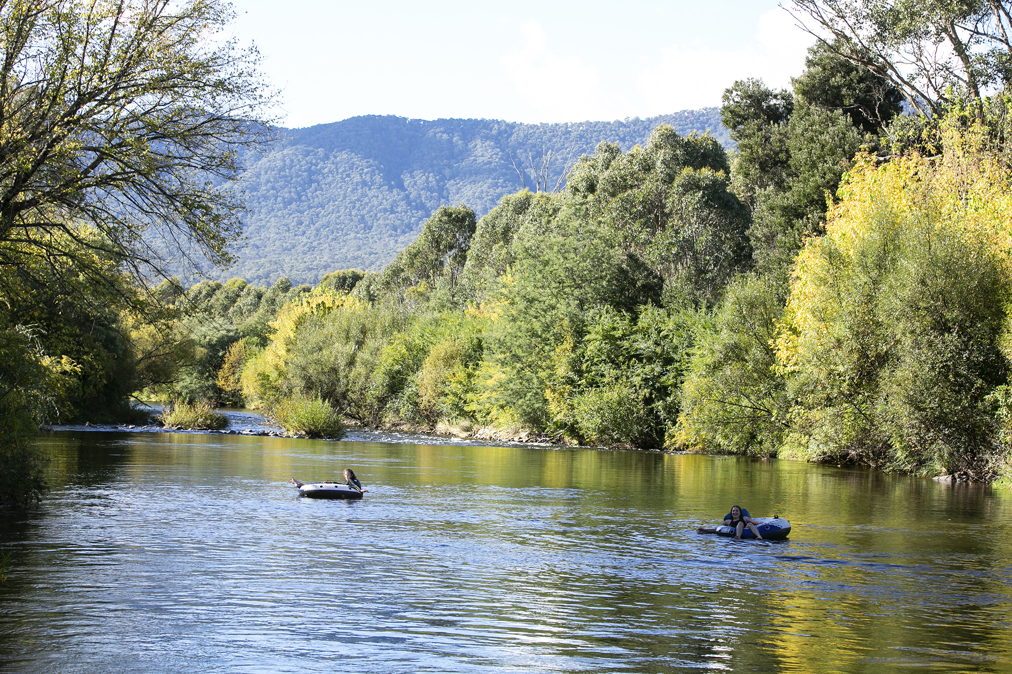 tawonga tourist park river with people floating midstream