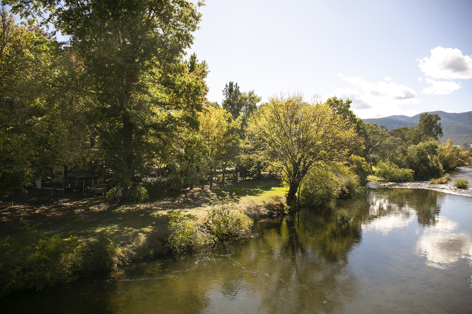 tawonga tourist park river with trees on edge and reflections in the water
